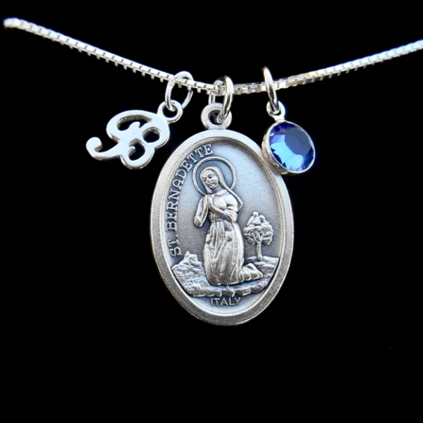 Saint Bernadette Medal shown with Personalized Birthstone and Initil Charms.